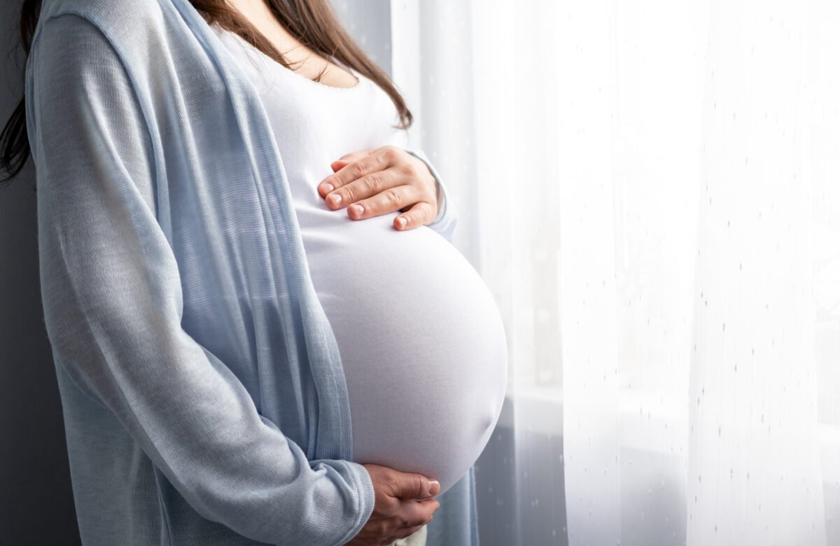 pregnant woman holding her stomach